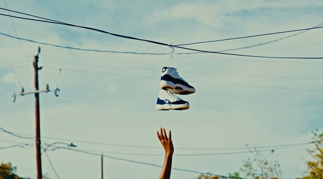 Air Jordan XI sneakers hanging from a power line