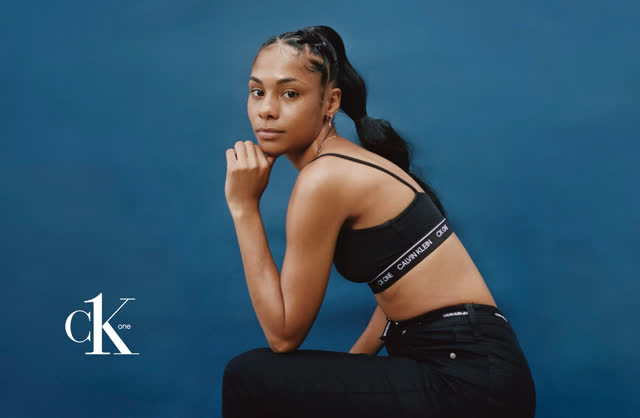 Model in Calvin Klein against a blue backdrop